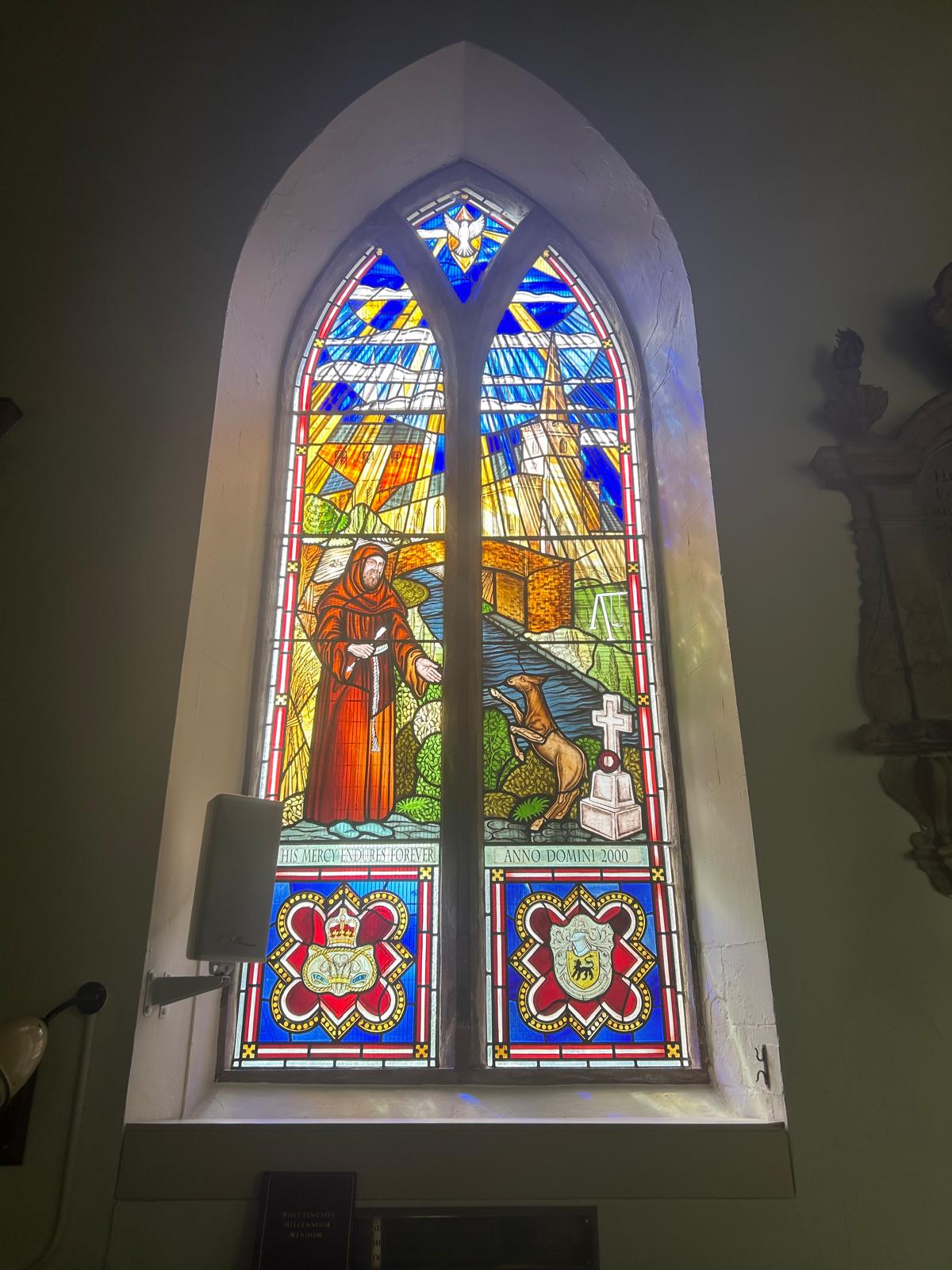The restored stained-glass window of St Giles at St Giles Church, Whittington